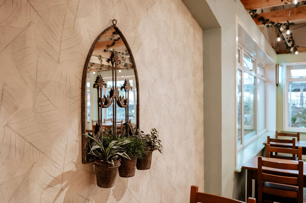 Leaves wallcovering featuring in the fresh new biophilic interiors at Cardwells Garden Centre in Scotland.