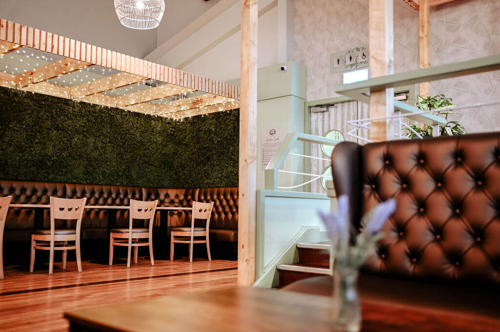 Leaves wallcovering featuring in the fresh new biophilic interiors at Cardwells Garden Centre in Scotland.