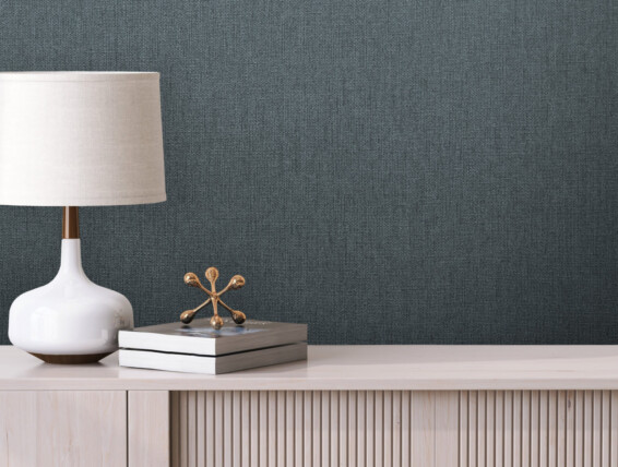 3D close up, a stylish contemporary white table lamp with gold lining and linen cloth lampshade stand next to some books on a minimal wooden sideboard. Empty blank beige wall in background. Mock up.